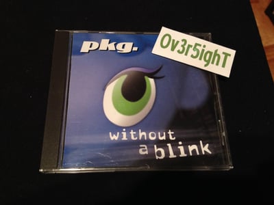 pkg. - Without A Blink (2001)