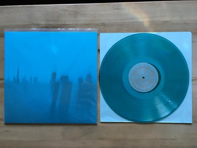 Is Survived By - 1st Press /698 - Transparent Light Blue